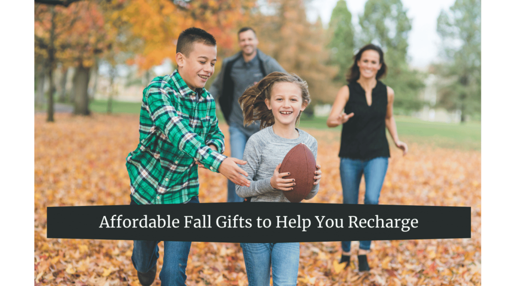 A family playing football in a park during fall, with autumn leaves covering the ground.